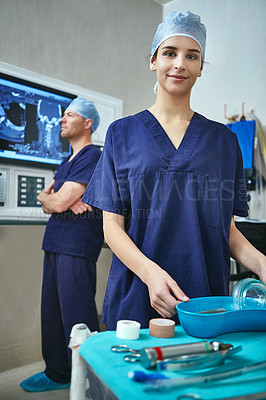 Buy stock photo Portrait of a female surgeon with her colleague standing in the background