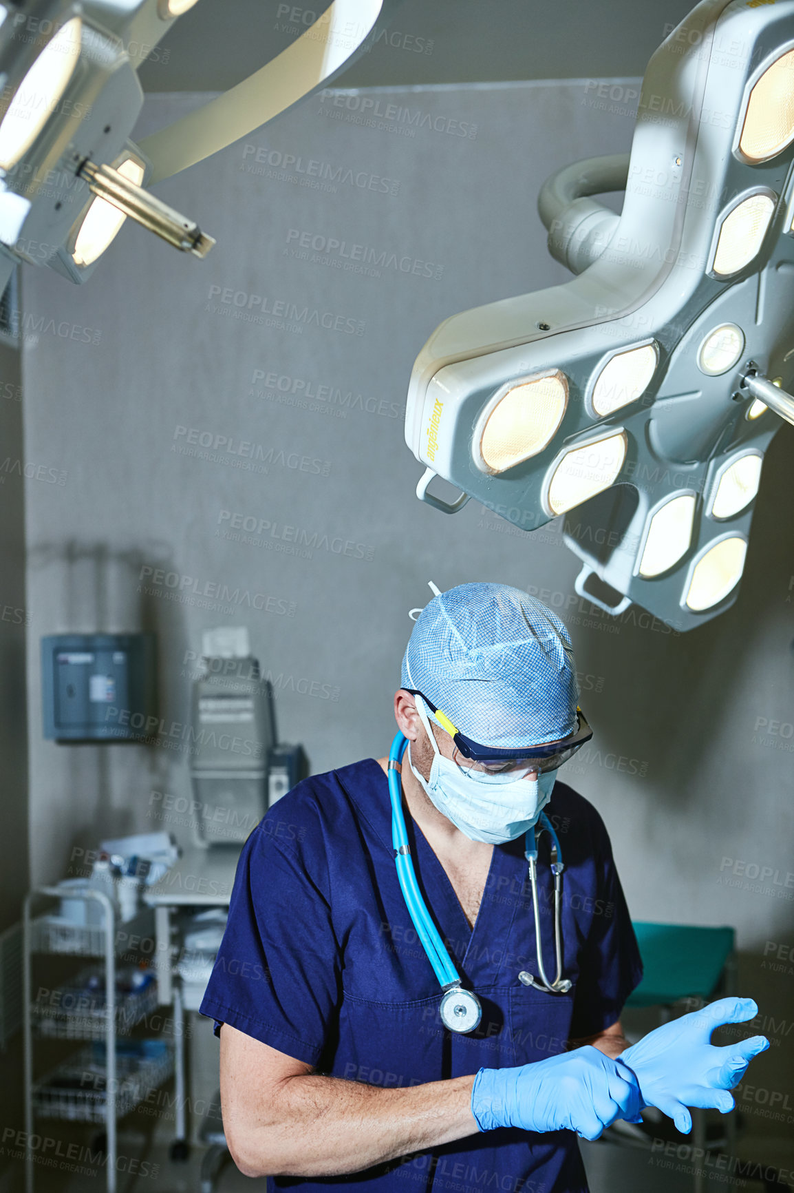 Buy stock photo Cropped shot of a surgeon in an operating room