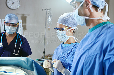 Buy stock photo Cropped shot of surgeons in an operating room