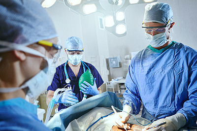 Buy stock photo Cropped shot of surgeons in an operating room