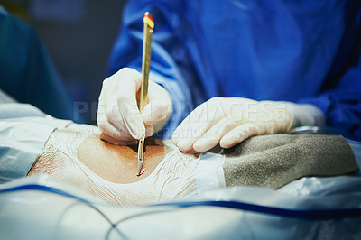 Buy stock photo Cropped shot of a surgeon in an operating room