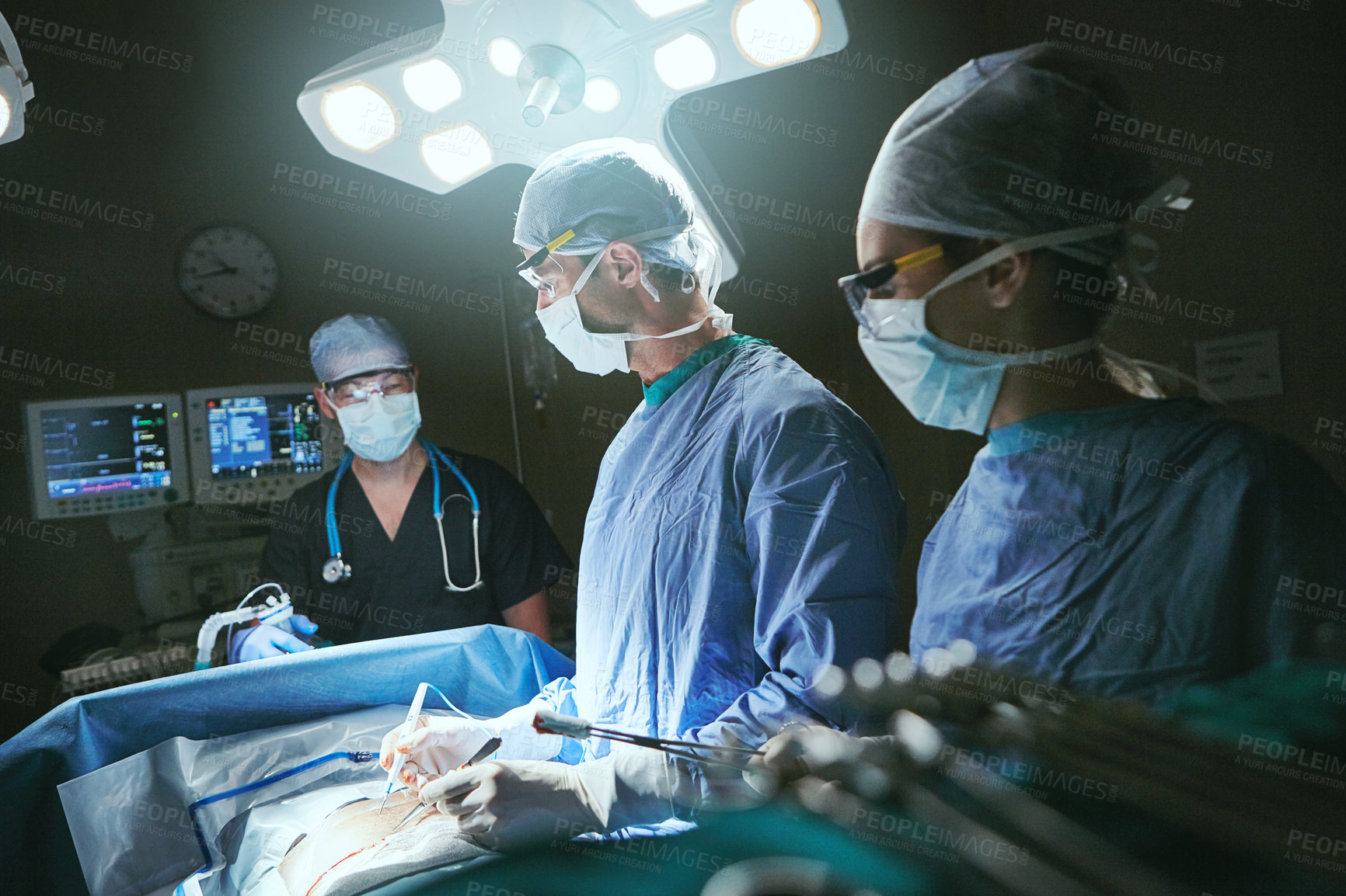 Buy stock photo Cropped shot of surgeons in an operating room