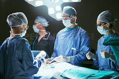 Buy stock photo Cropped shot of surgeons in an operating room