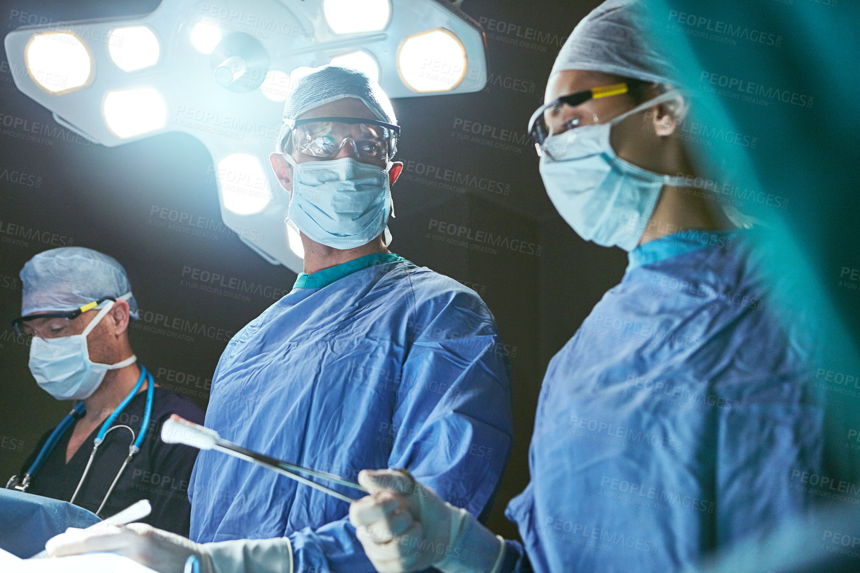 Buy stock photo Cropped shot of surgeons in an operating room