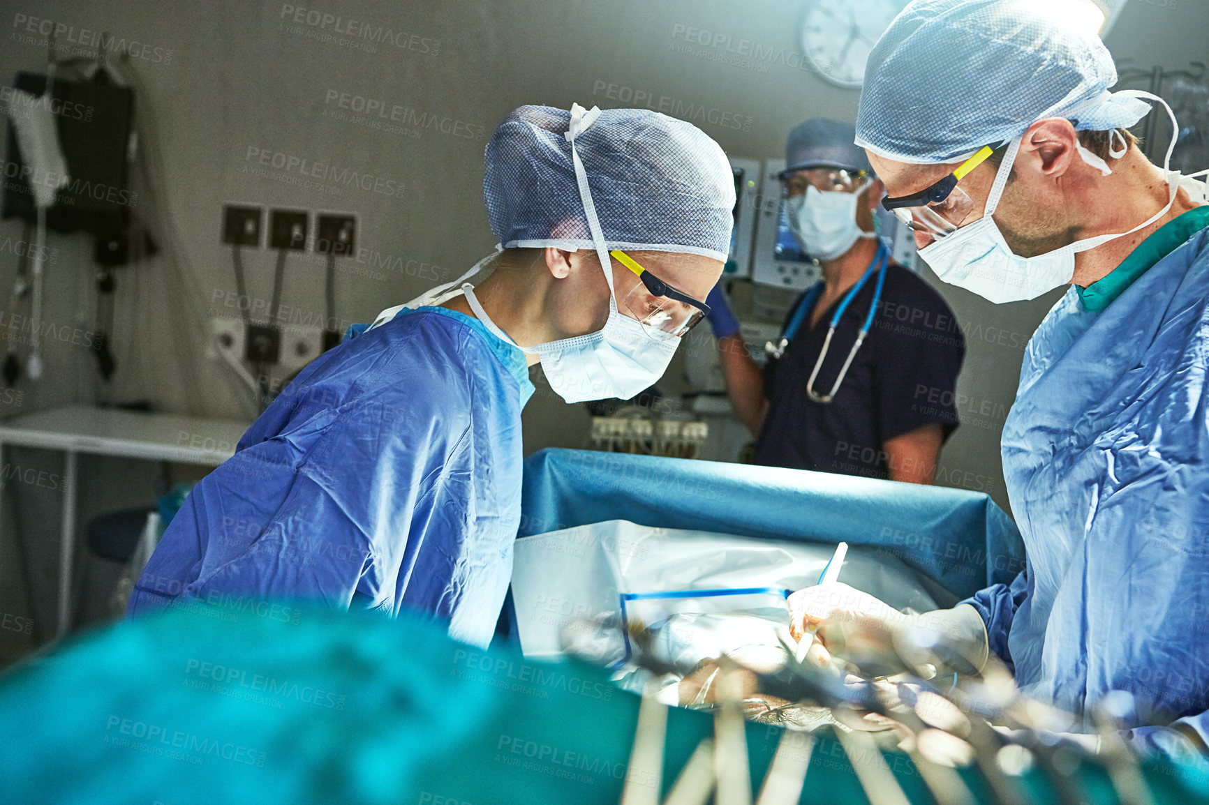 Buy stock photo Cropped shot of surgeons in an operating room