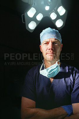 Buy stock photo Cropped portrait of a male doctor against a dark background