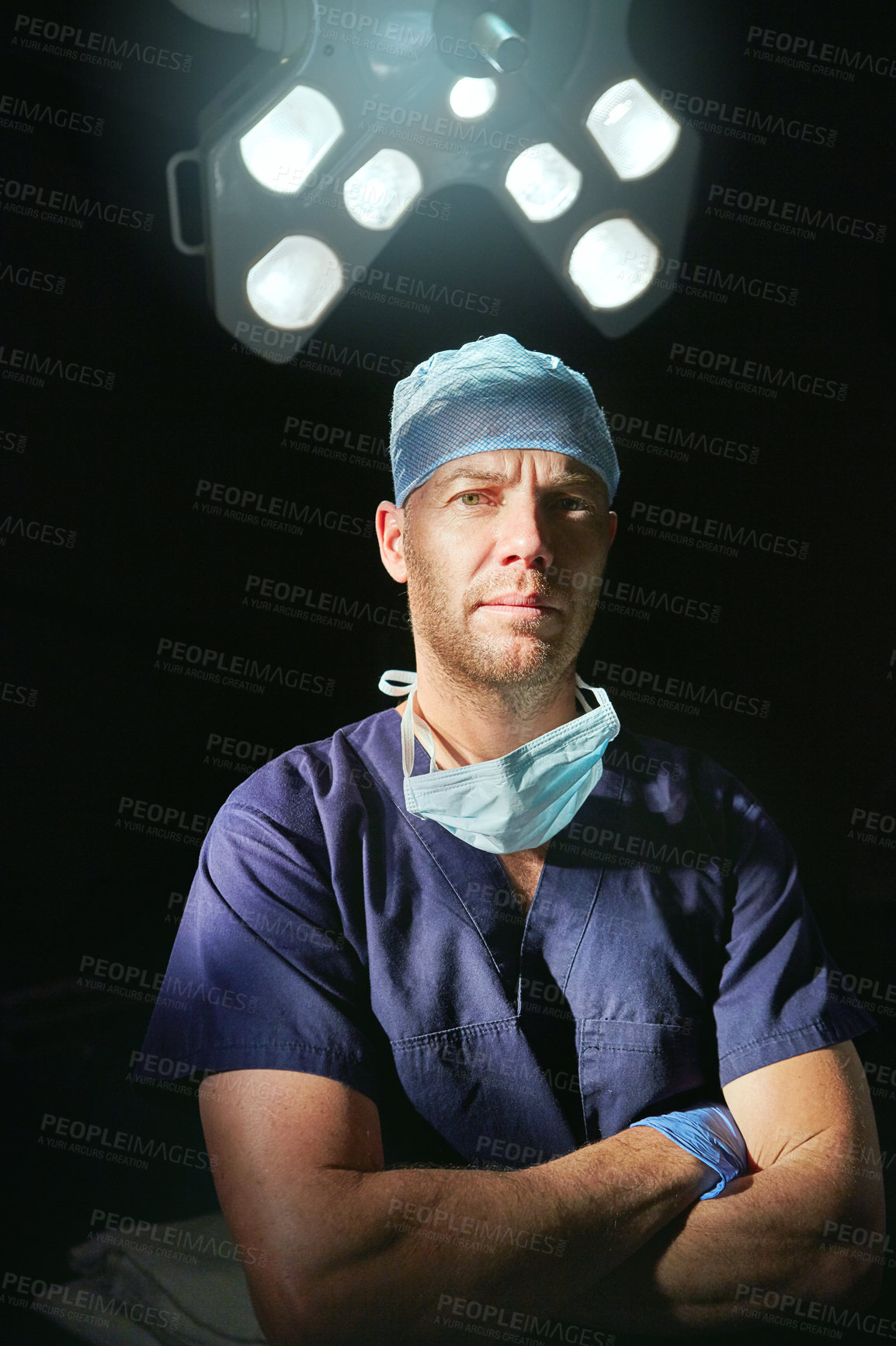 Buy stock photo Cropped portrait of a male doctor against a dark background