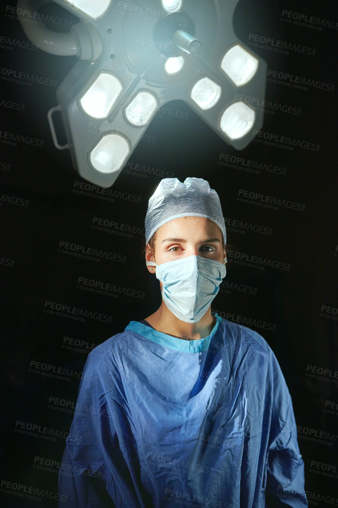 Buy stock photo Cropped portrait of a female doctor against a dark background