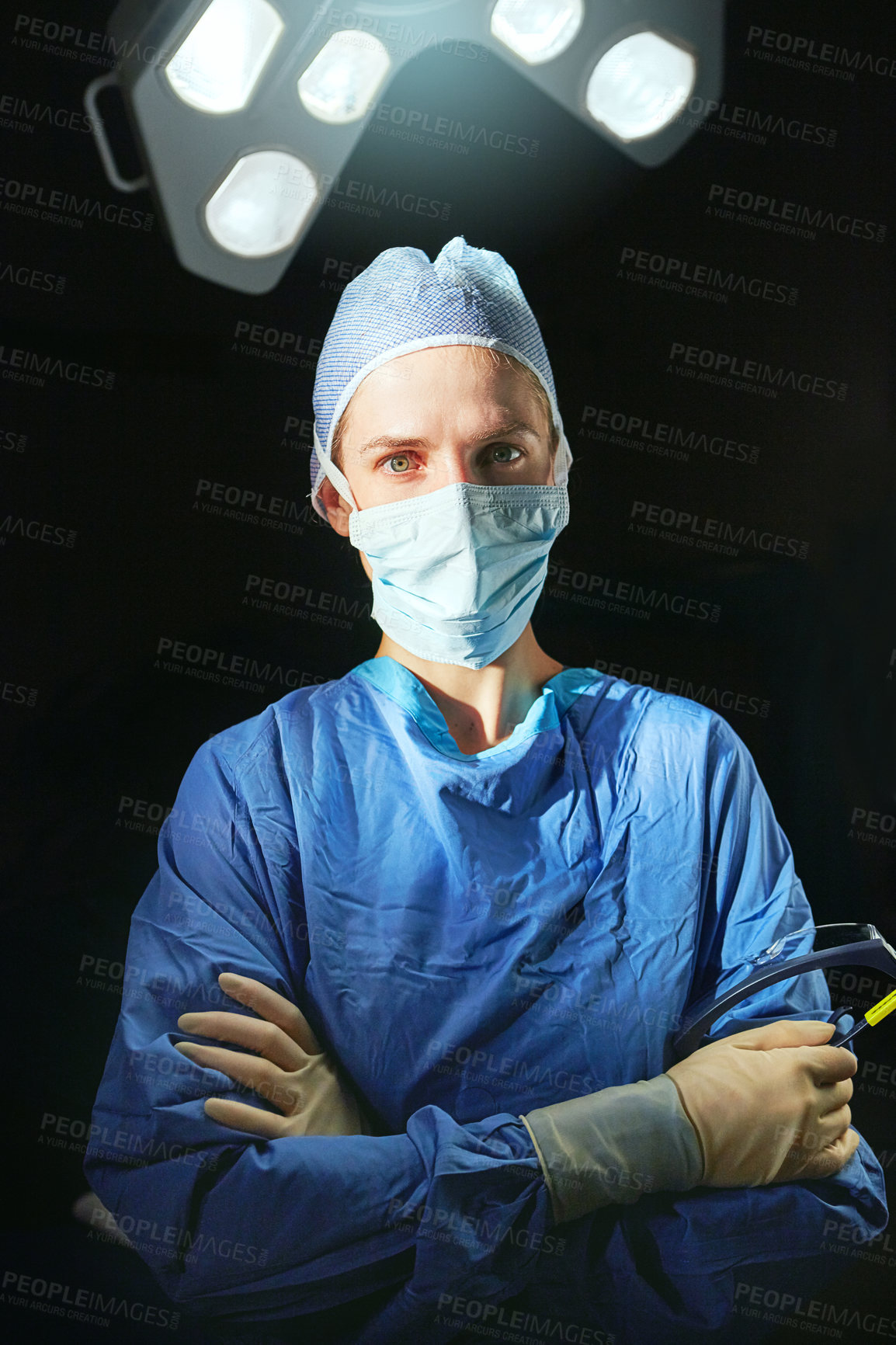 Buy stock photo Cropped portrait of a female doctor against a dark background