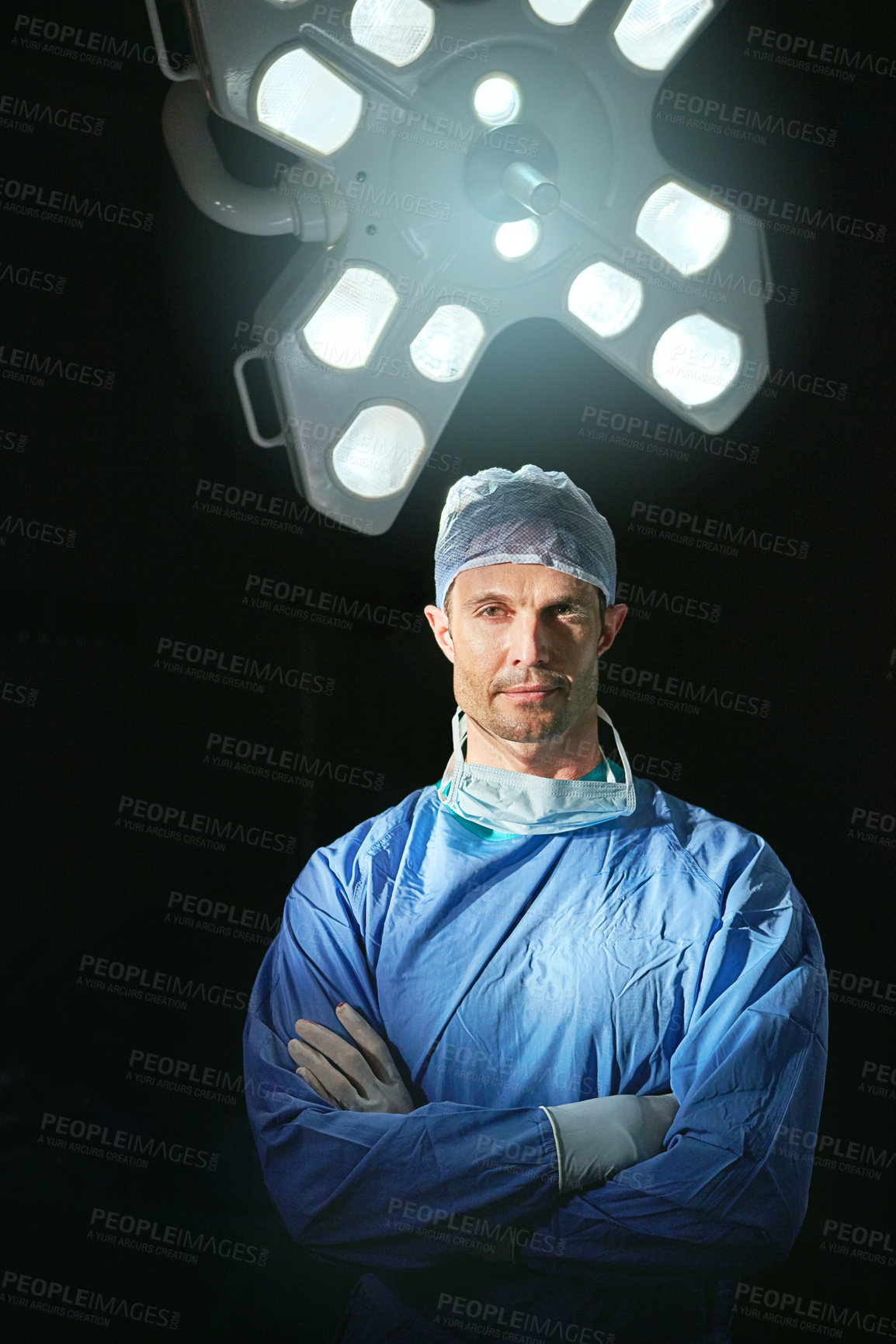 Buy stock photo Cropped portrait of a male doctor against a dark background