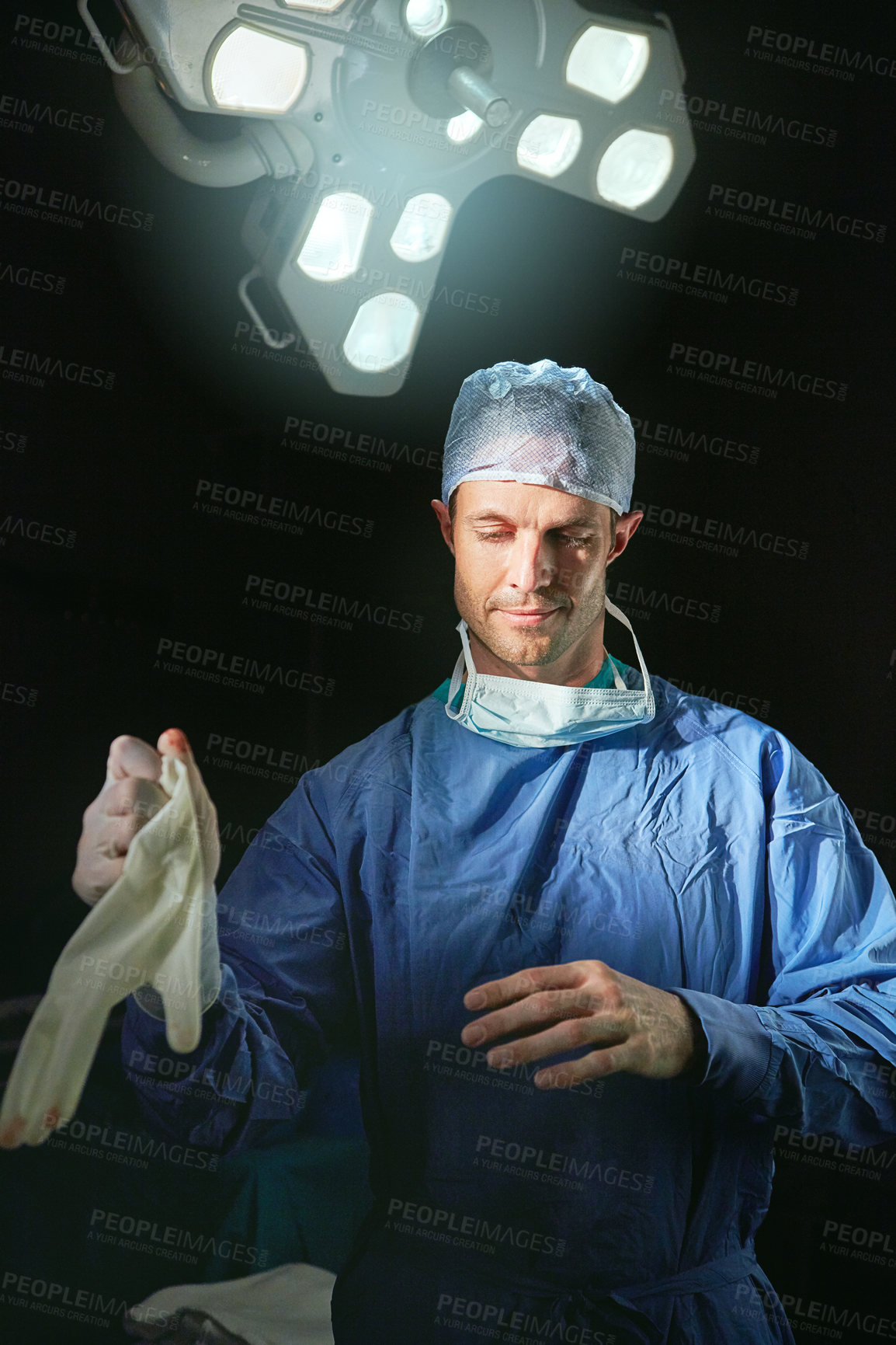 Buy stock photo Cropped portrait of a male doctor against a dark background