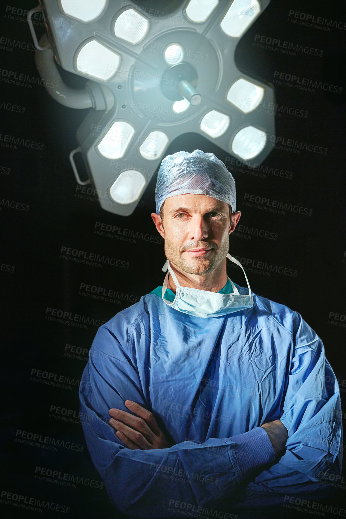 Buy stock photo Cropped portrait of a male doctor against a dark background