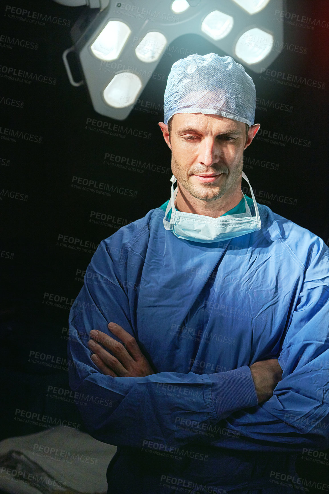 Buy stock photo Cropped portrait of a male doctor against a dark background