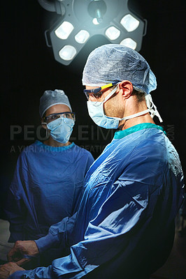 Buy stock photo Cropped shot of two doctors against a dark background