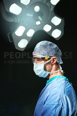 Buy stock photo Cropped shot of a doctor against a dark background