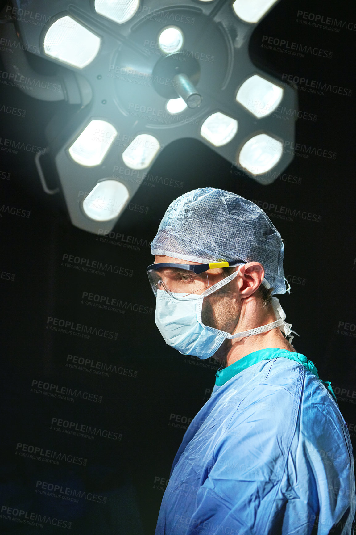 Buy stock photo Cropped shot of a doctor against a dark background