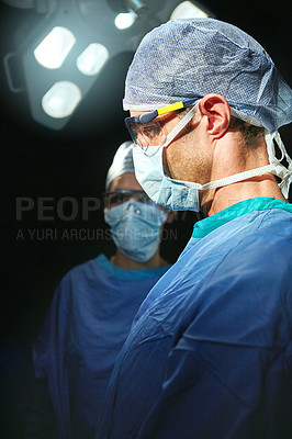 Buy stock photo Cropped shot of a doctor against a dark background