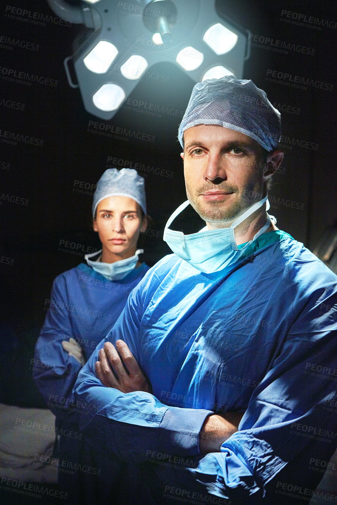 Buy stock photo Cropped portrait of two doctors against a dark background