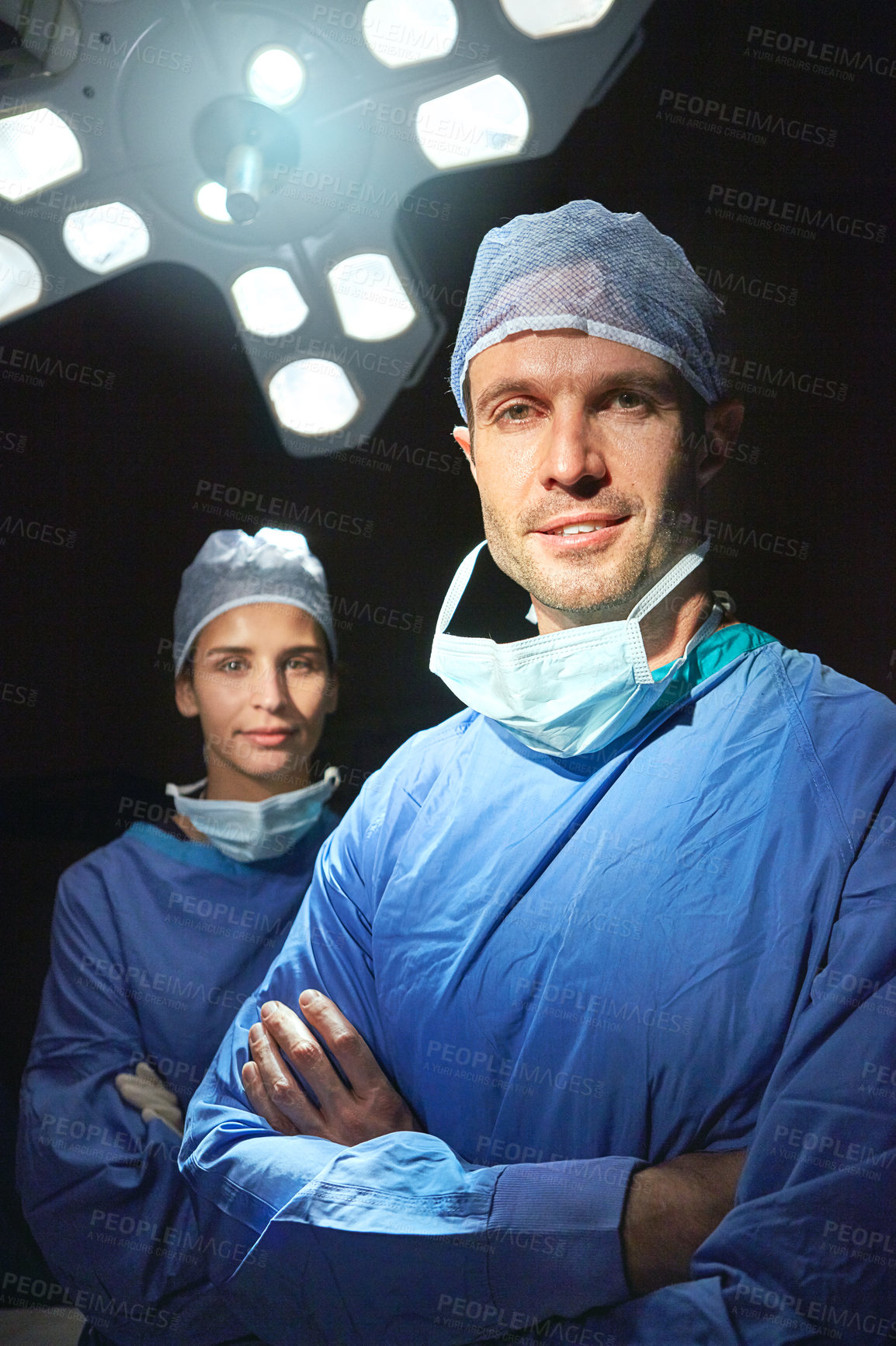 Buy stock photo Cropped portrait of two doctors against a dark background