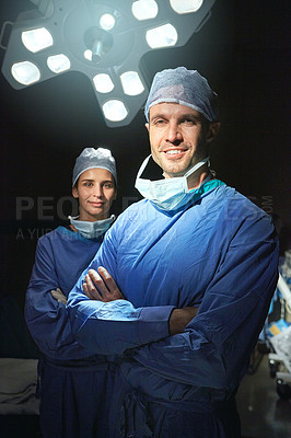 Buy stock photo Cropped portrait of two doctors against a dark background
