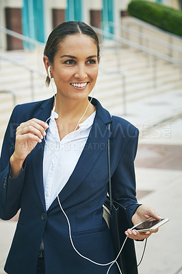 Buy stock photo Shot of a young businesswoman talking on her phone while out in the city