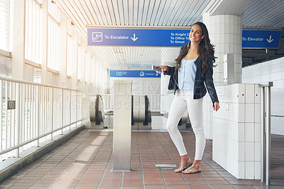 Buy stock photo Shot of a young woman dancing to music on a phone in an urban setting