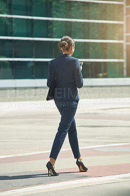 Buy stock photo Shot of a young businesswoman on the move in the city