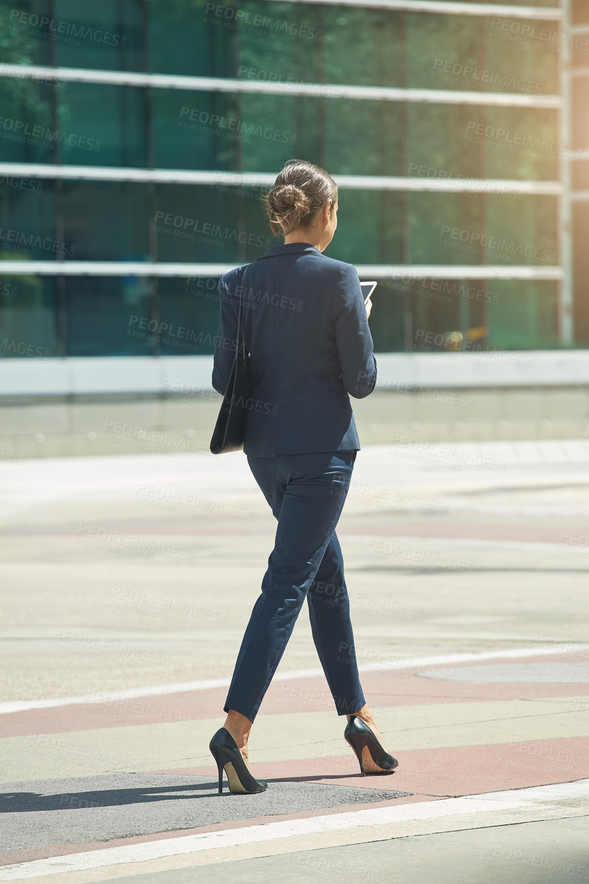 Buy stock photo Shot of a young businesswoman on the move in the city