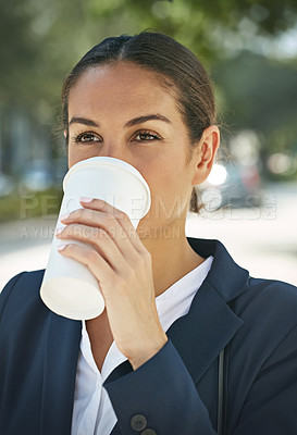 Buy stock photo Shot of a modern businesswoman drinking a cup of coffee outdoors