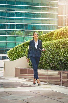 Buy stock photo Shot of a young businesswoman on the move in the city