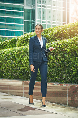 Buy stock photo Shot of a young businesswoman on the move in the city