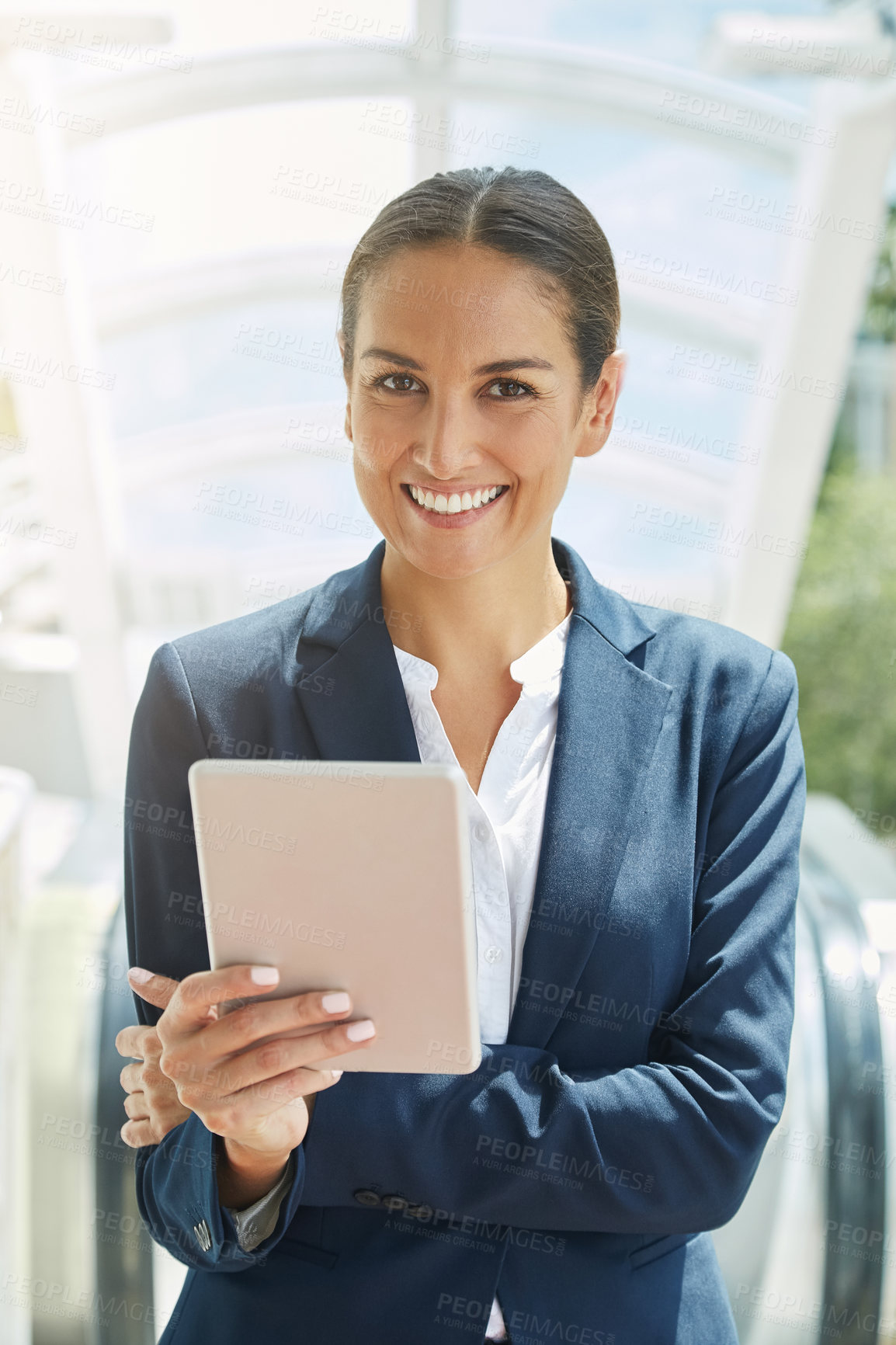 Buy stock photo Portrait of a young businesswoman using a digital tablet on her way to the office