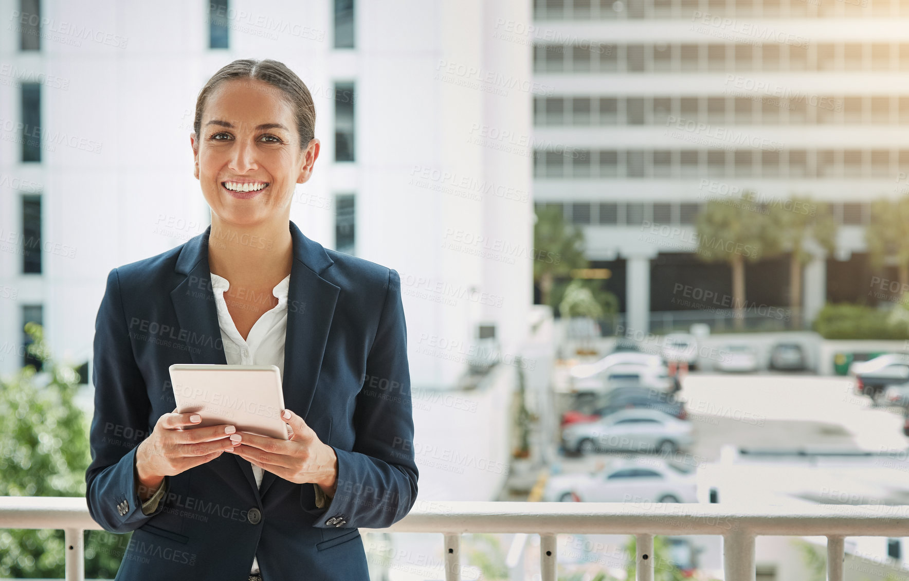 Buy stock photo Portrait of a young businesswoman using a digital tablet on her way to the office