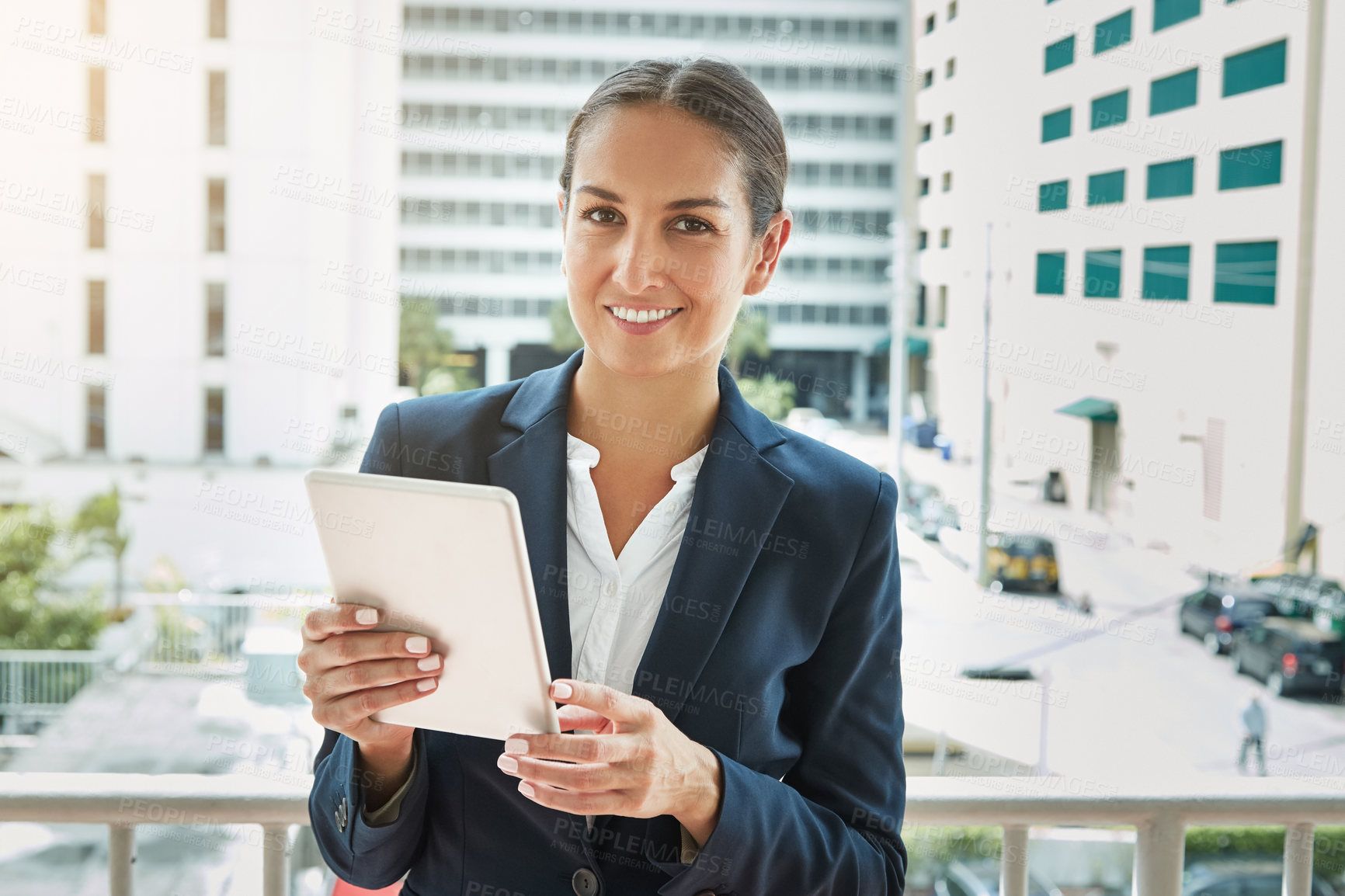 Buy stock photo Portrait of a young businesswoman using a digital tablet on her way to the office