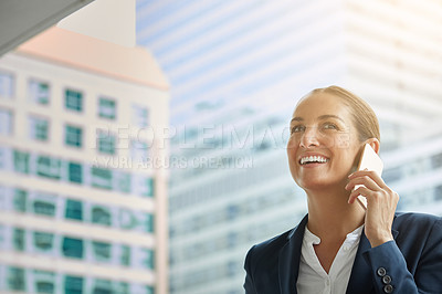 Buy stock photo Shot of a young businesswoman talking on her cellphone on the way to the office