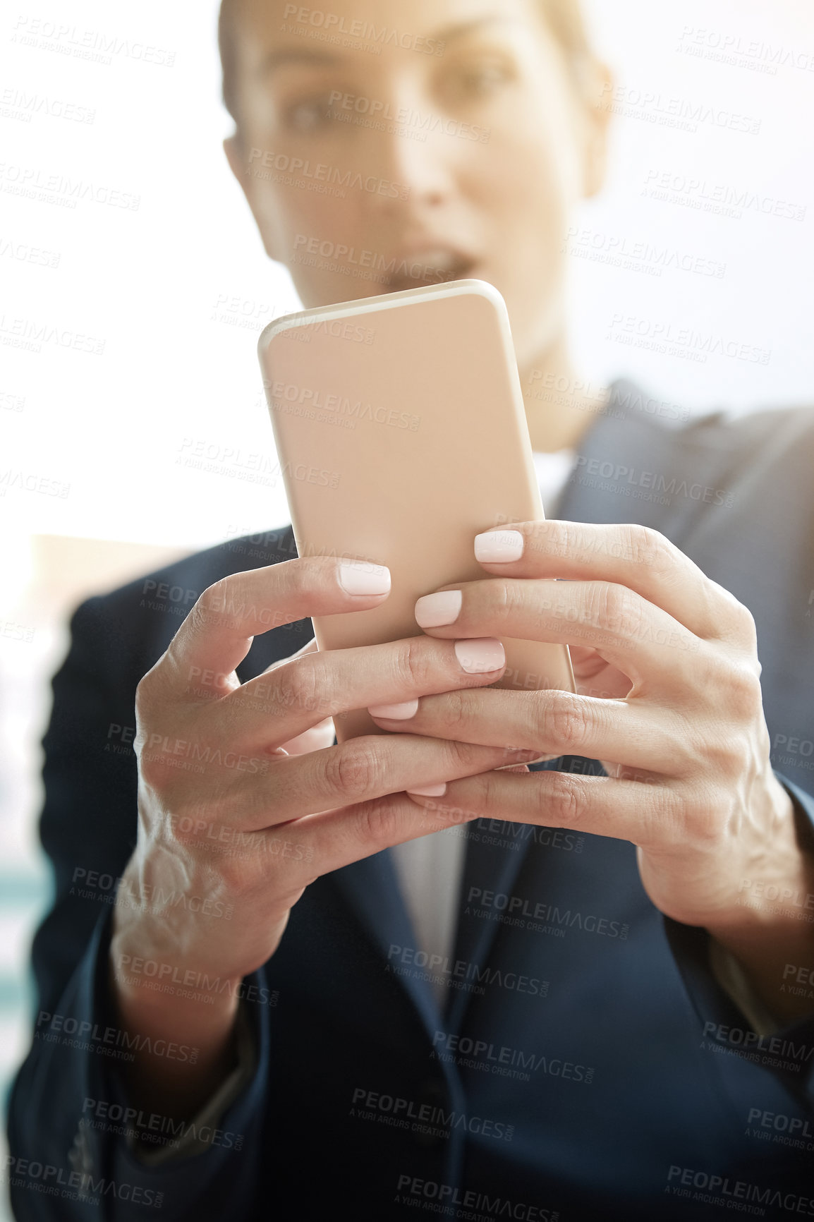 Buy stock photo Shot of a young businesswoman using a cellphone on the way to the office