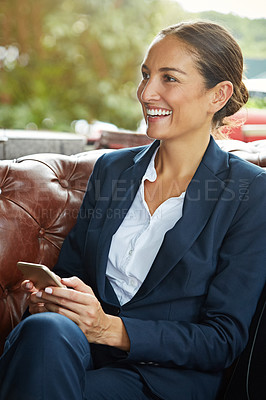 Buy stock photo Shot of a young businesswoman using a cellphone