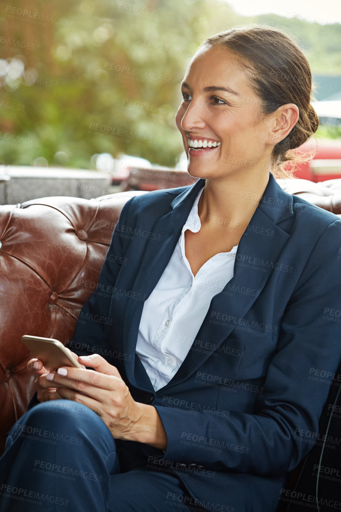 Buy stock photo Shot of a young businesswoman using a cellphone