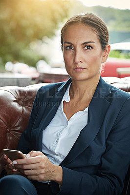 Buy stock photo Portrait of a young businesswoman using a cellphone