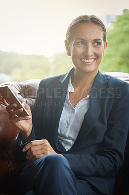 Buy stock photo Shot of a young businesswoman using a cellphone