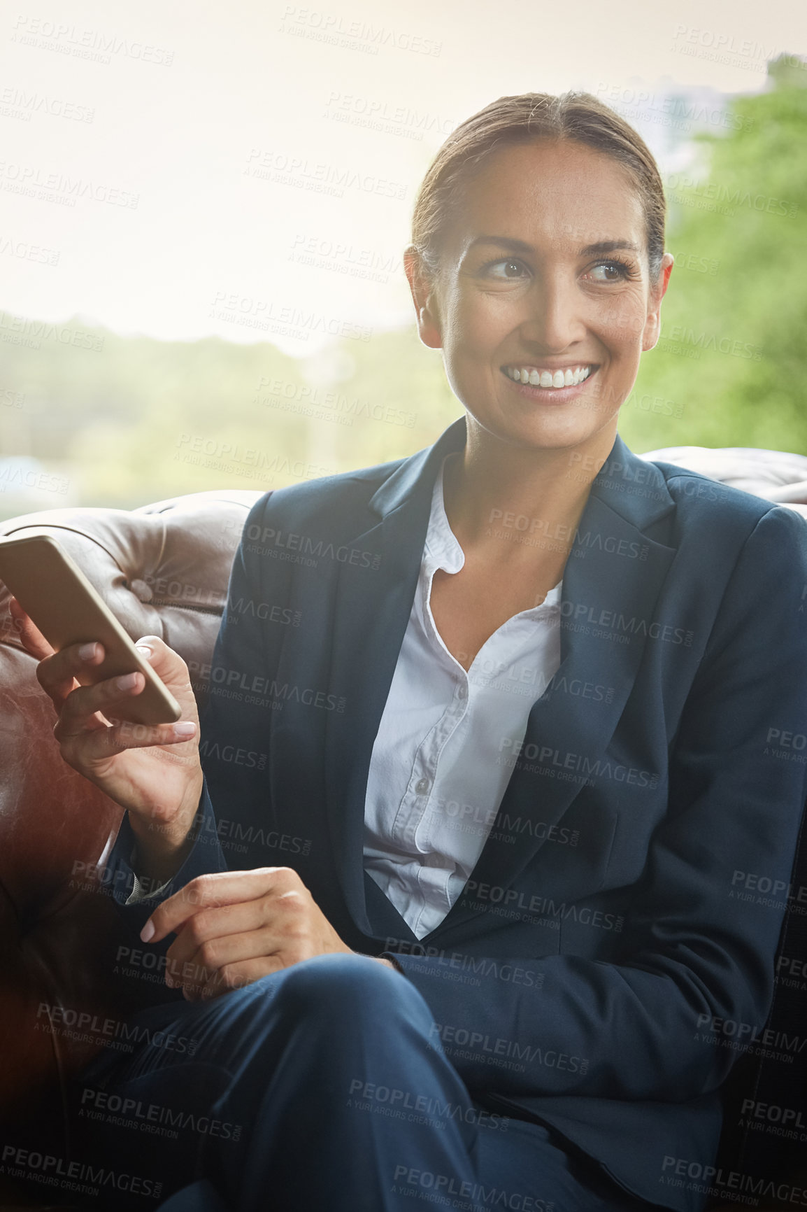 Buy stock photo Shot of a young businesswoman using a cellphone