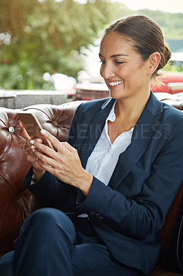 Buy stock photo Shot of a young businesswoman using a cellphone