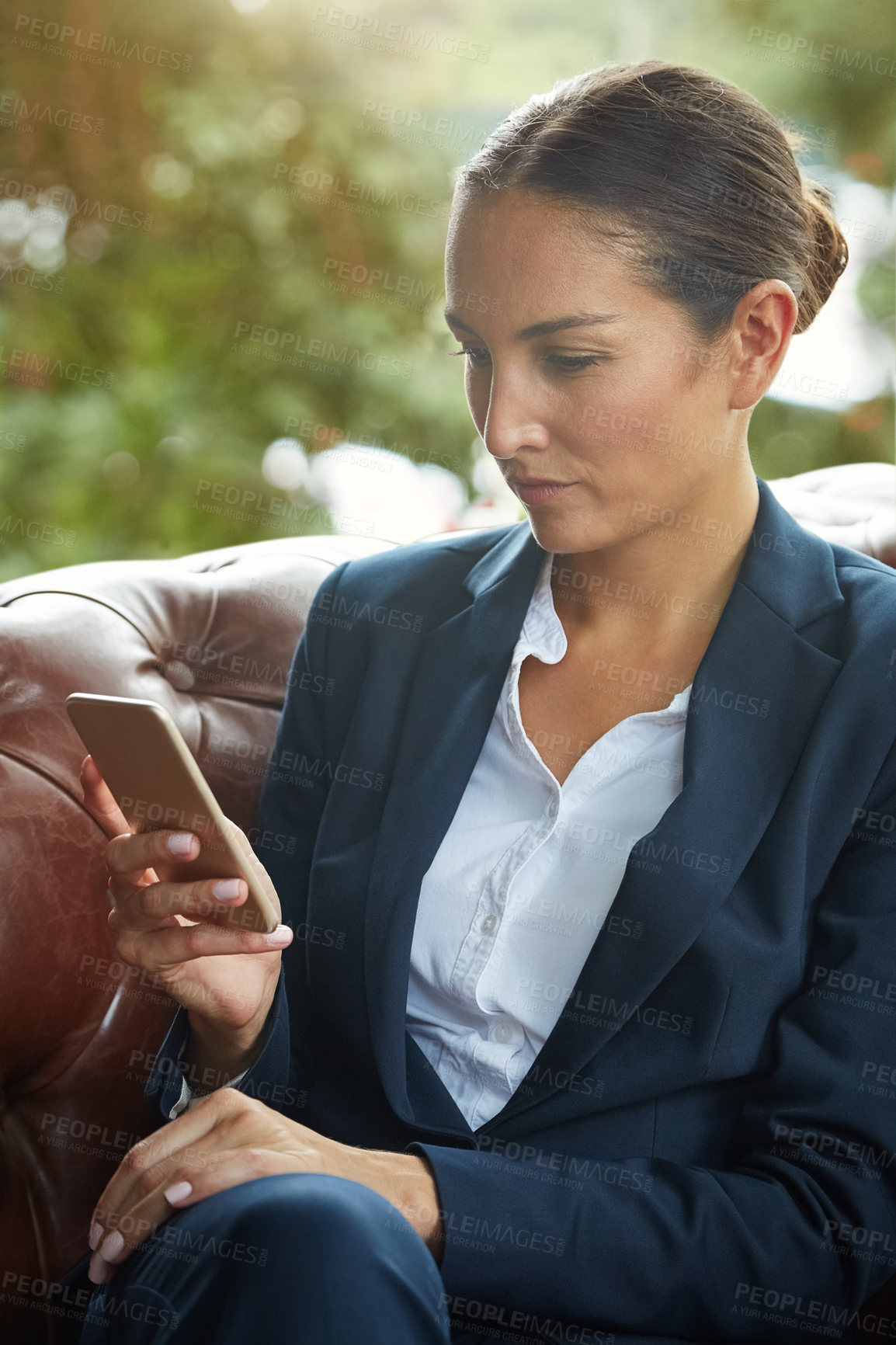 Buy stock photo Shot of a young businesswoman using a cellphone