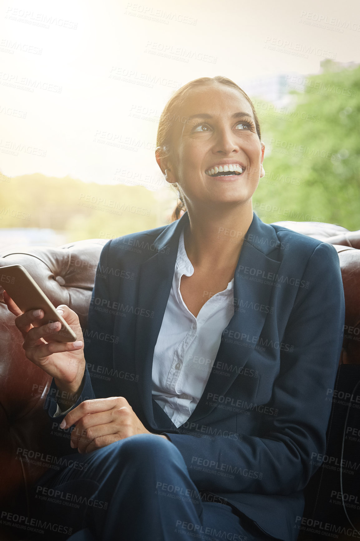 Buy stock photo Shot of a young businesswoman using a cellphone