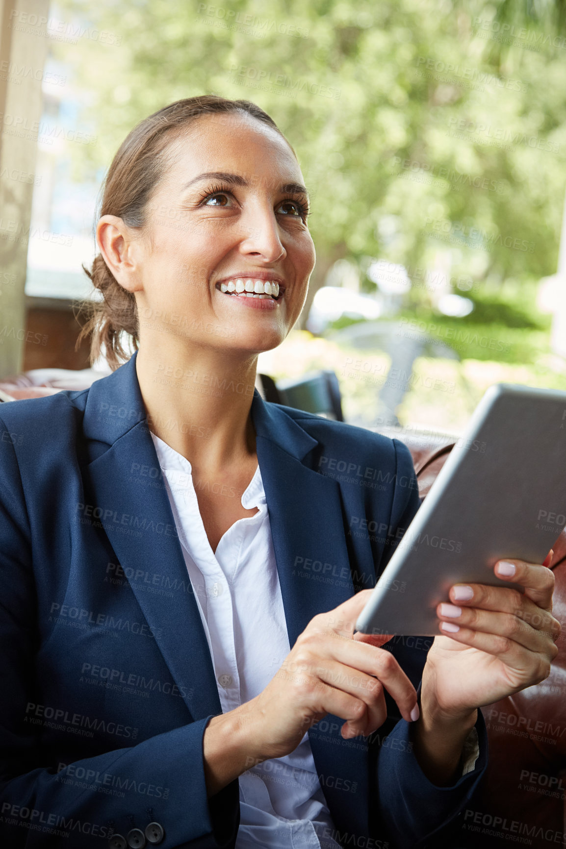 Buy stock photo Shot of a young businesswoman using a digital tablet