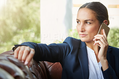 Buy stock photo Shot of a young businesswoman talking on a cellphone