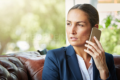 Buy stock photo Shot of a young businesswoman talking on a cellphone