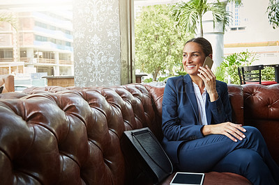 Buy stock photo Shot of a young businesswoman talking on a cellphone