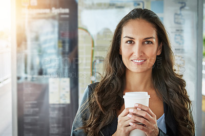 Buy stock photo Portrait of a young woman holding a cup of coffee in an urban setting