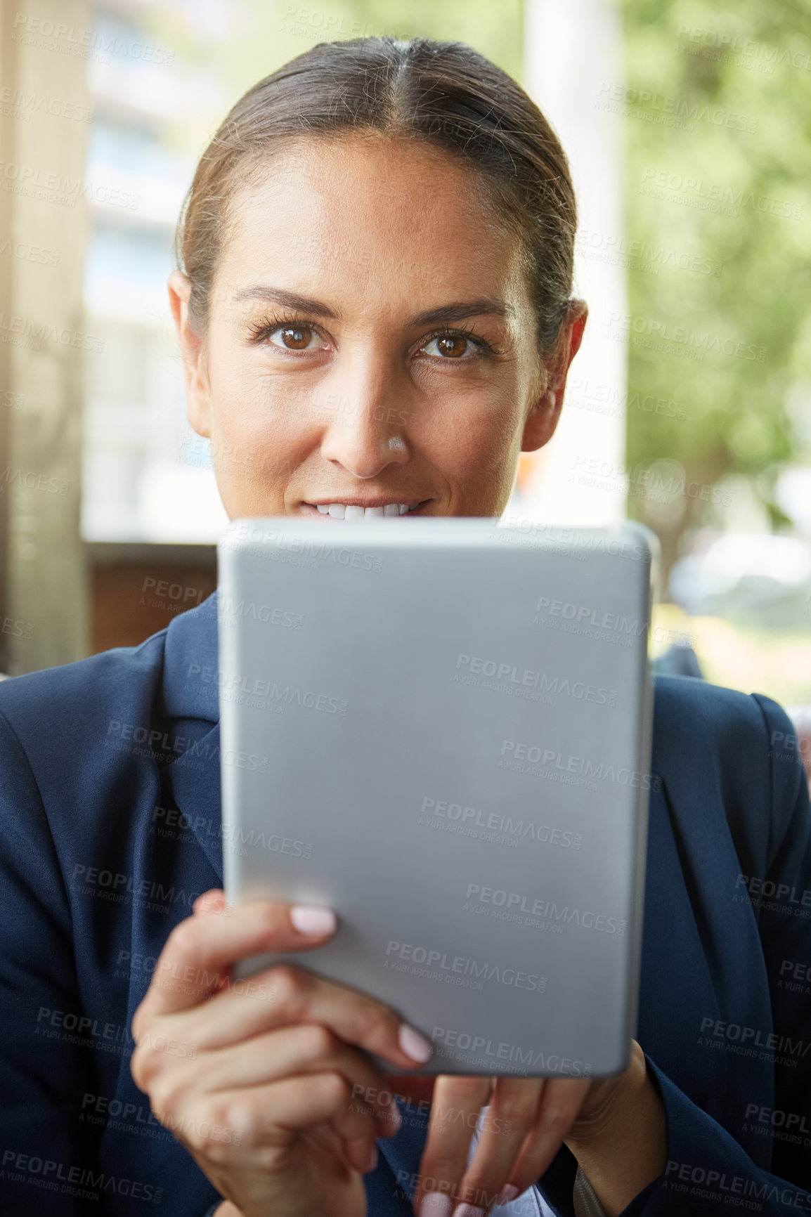 Buy stock photo Portrait of a young businesswoman using a digital tablet outside